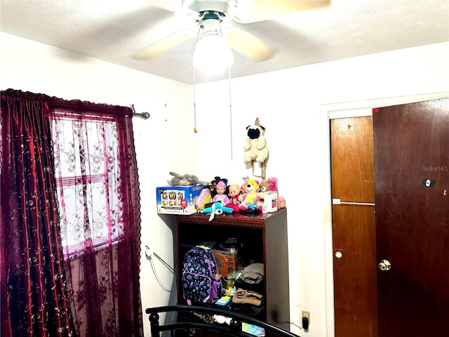 bedroom with a textured ceiling and ceiling fan