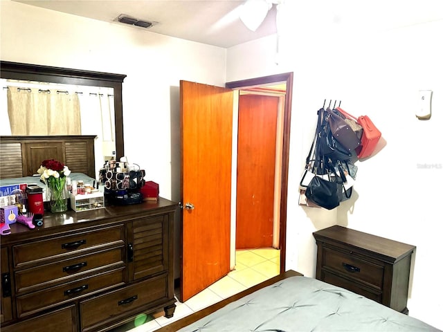 bedroom with ceiling fan and light tile patterned floors