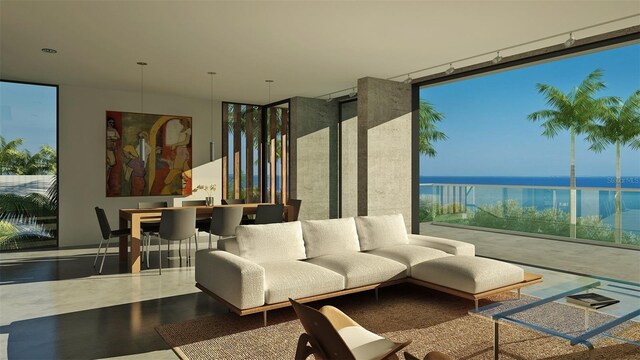 interior space with concrete floors, expansive windows, and a water view