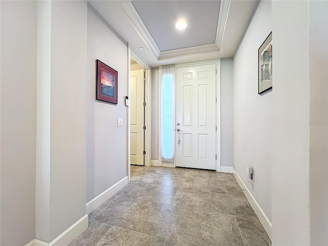 interior space featuring a raised ceiling and crown molding