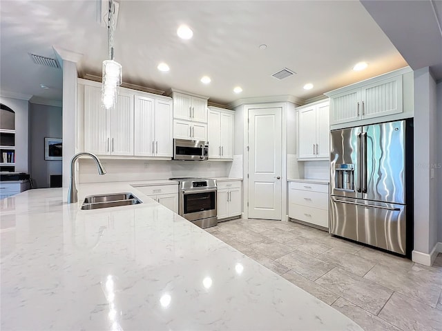 kitchen featuring sink, appliances with stainless steel finishes, light stone countertops, light tile patterned floors, and hanging light fixtures