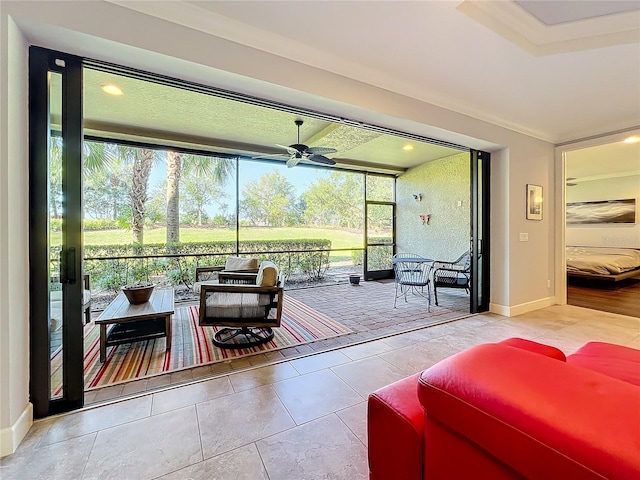 sunroom featuring a wealth of natural light and ceiling fan