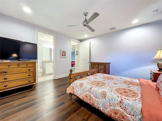 bedroom featuring dark hardwood / wood-style flooring, ensuite bath, and ceiling fan