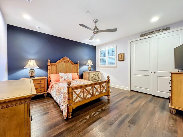 bedroom featuring ceiling fan, a closet, and dark wood-type flooring