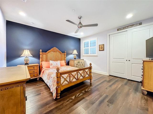 bedroom with a ceiling fan, baseboards, dark wood finished floors, and a closet