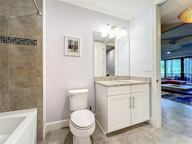 full bathroom with tile patterned flooring, toilet, tiled shower / bath combo, and vanity