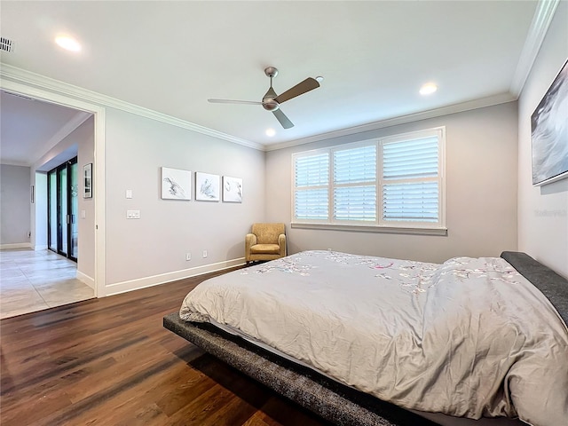 bedroom with ceiling fan, crown molding, and hardwood / wood-style flooring