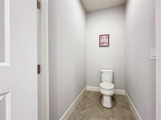 bathroom with toilet and tile patterned floors