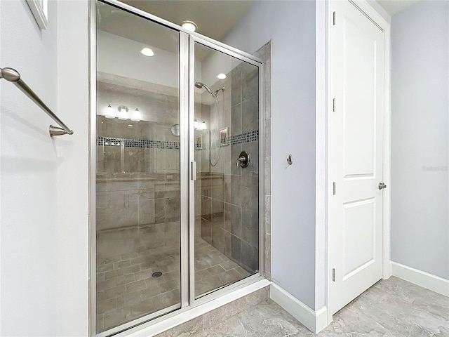 bathroom featuring tile patterned flooring and an enclosed shower