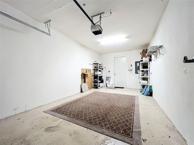 garage featuring a garage door opener and electric panel