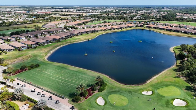 birds eye view of property featuring view of golf course, a water view, and a residential view