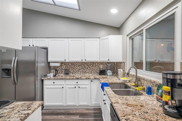 kitchen featuring dark hardwood / wood-style floors, white cabinetry, appliances with stainless steel finishes, sink, and lofted ceiling