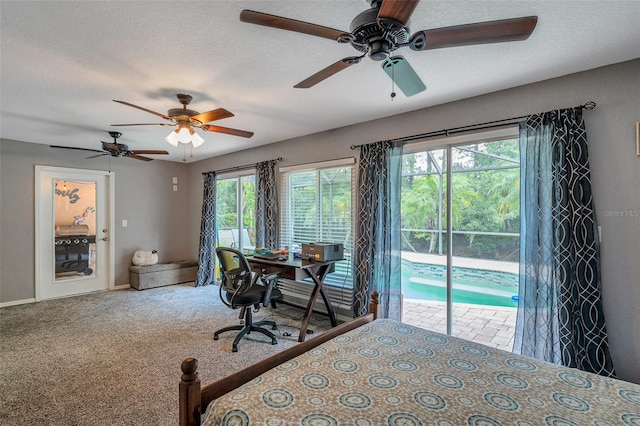 carpeted bedroom with a textured ceiling, ceiling fan, multiple windows, and access to outside