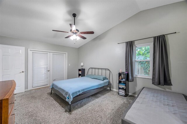 bedroom with ceiling fan, carpet flooring, and vaulted ceiling