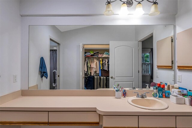 bathroom with vaulted ceiling and vanity