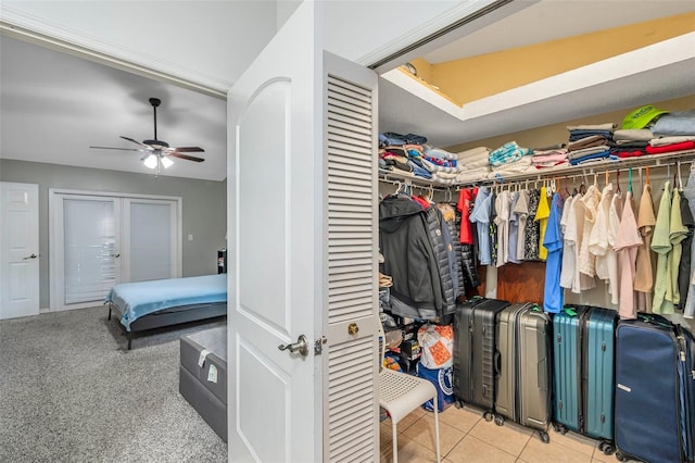 spacious closet with ceiling fan and light tile patterned floors