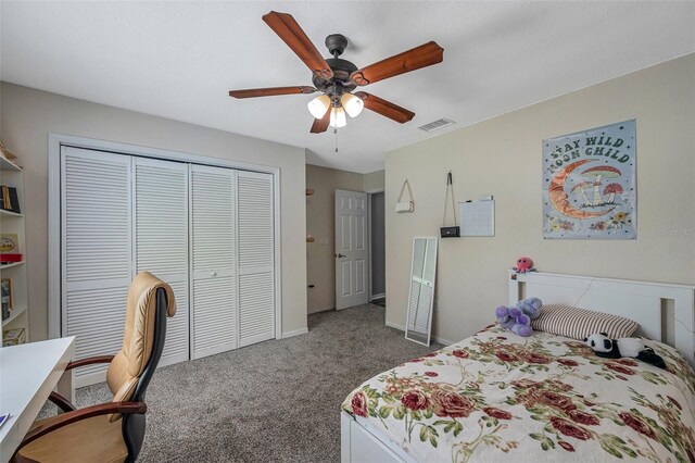 carpeted bedroom with ceiling fan and a closet