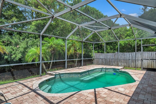 view of swimming pool with a lanai and a patio area