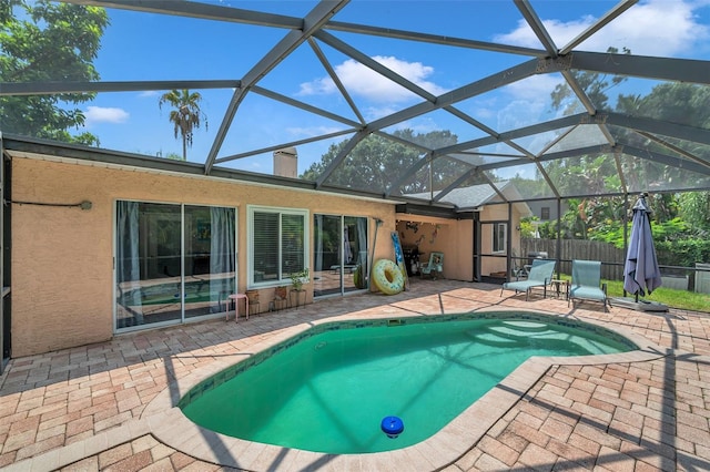 view of pool with a patio area and a lanai