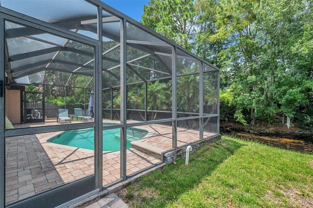 view of pool featuring a patio area and glass enclosure