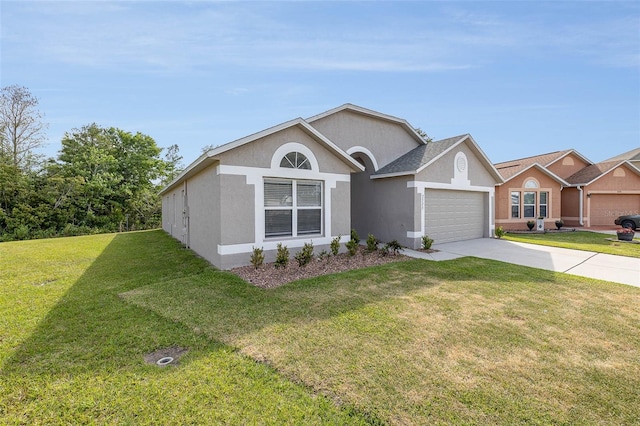 single story home with a garage and a front lawn