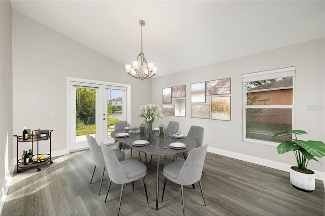 dining room with high vaulted ceiling, wood-type flooring, french doors, and a chandelier