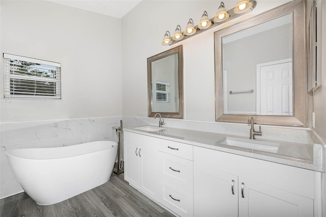 bathroom with tile walls, hardwood / wood-style flooring, and double sink vanity