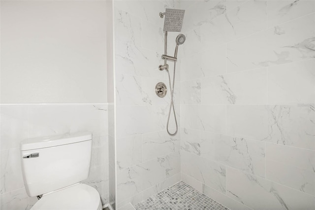 bathroom with tiled shower and toilet