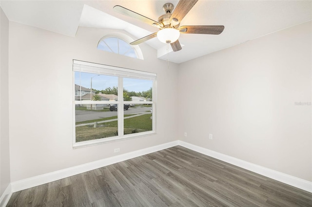 empty room with ceiling fan, wood-type flooring, and lofted ceiling