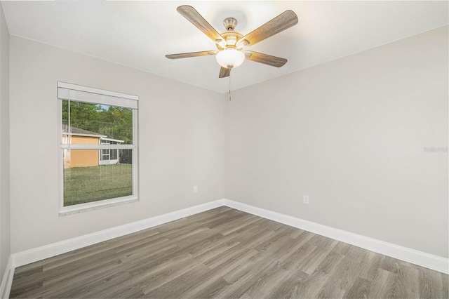 unfurnished room with ceiling fan and hardwood / wood-style flooring