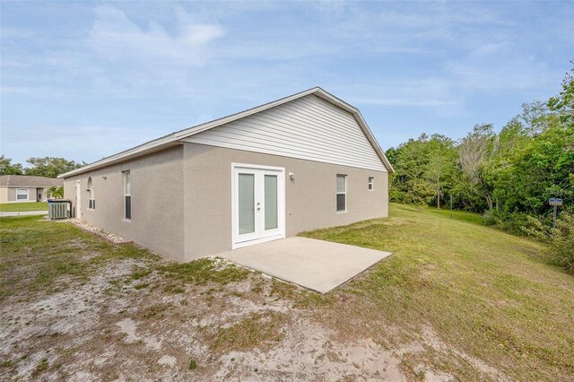 back of property featuring a patio, french doors, and a lawn