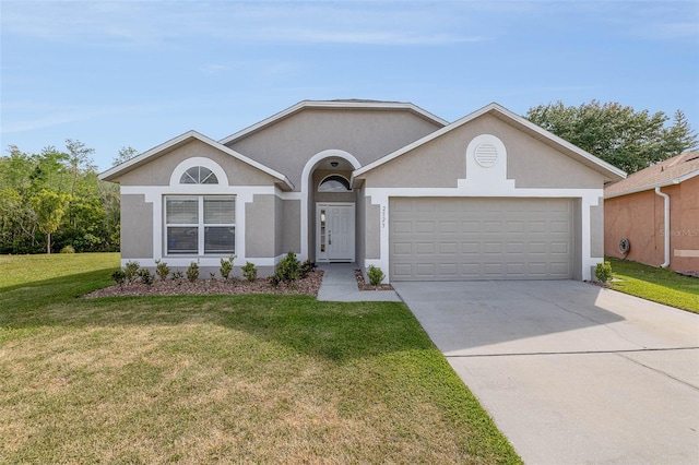 ranch-style house featuring stucco siding, a garage, concrete driveway, and a front yard