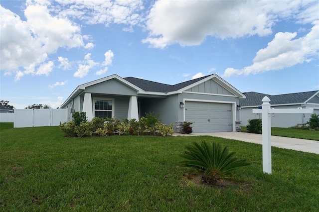 ranch-style house featuring a garage and a front lawn