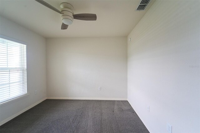 spare room featuring ceiling fan and carpet floors