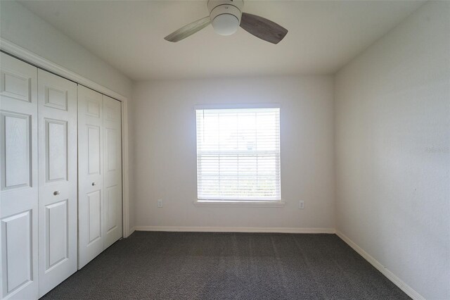 unfurnished bedroom with carpet flooring, ceiling fan, and multiple windows