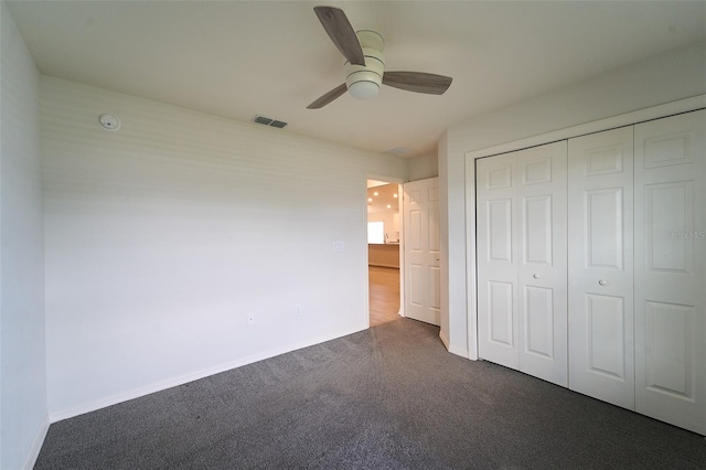 unfurnished bedroom featuring carpet floors, a closet, and ceiling fan