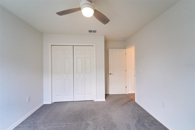 unfurnished bedroom with ceiling fan, a closet, and carpet flooring