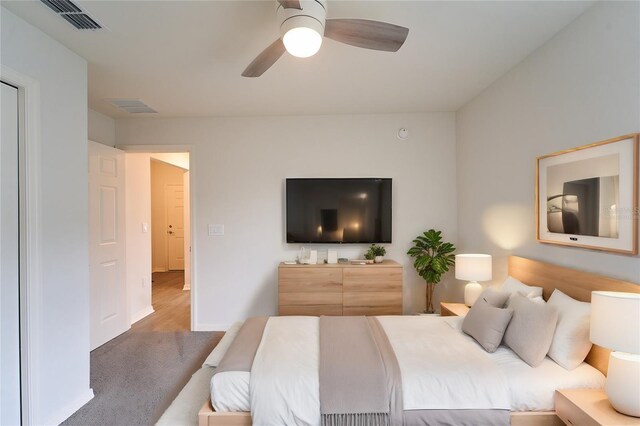 bedroom with ceiling fan and hardwood / wood-style flooring