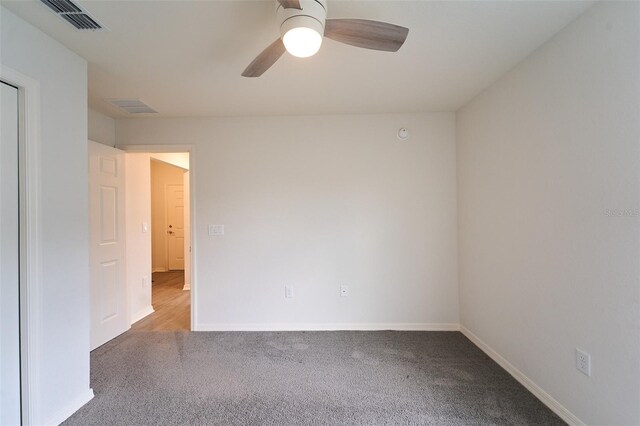 spare room with ceiling fan and carpet