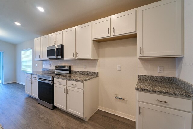 kitchen featuring dark hardwood / wood-style flooring, tasteful backsplash, white cabinetry, and stainless steel appliances