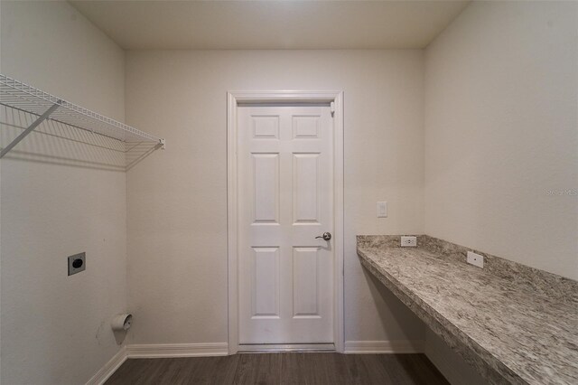 laundry area with hookup for an electric dryer and dark hardwood / wood-style flooring