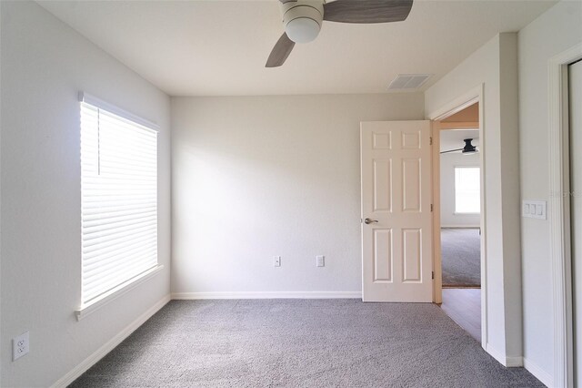 unfurnished bedroom with multiple windows and carpet floors