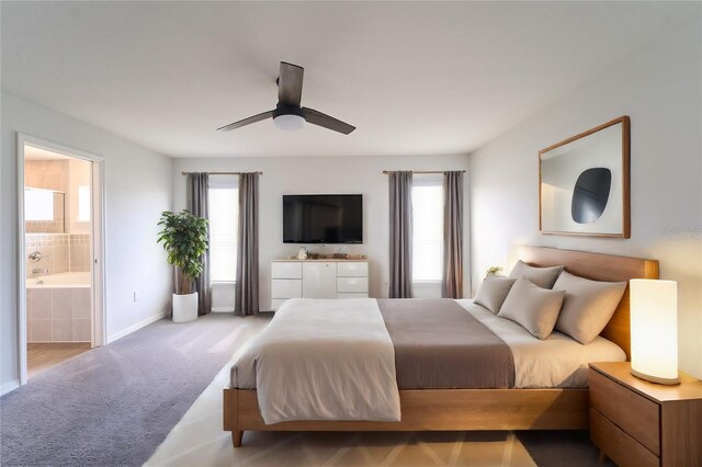 bedroom featuring ceiling fan and ensuite bath