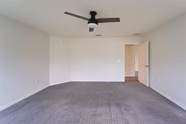 carpeted spare room featuring ceiling fan