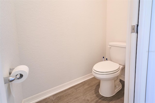 bathroom with wood-type flooring and toilet