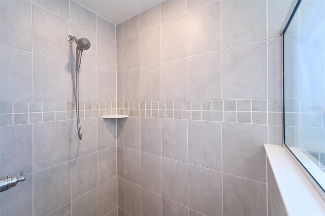 bathroom with tiled shower