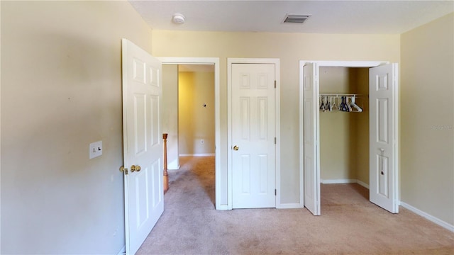 unfurnished bedroom featuring light carpet