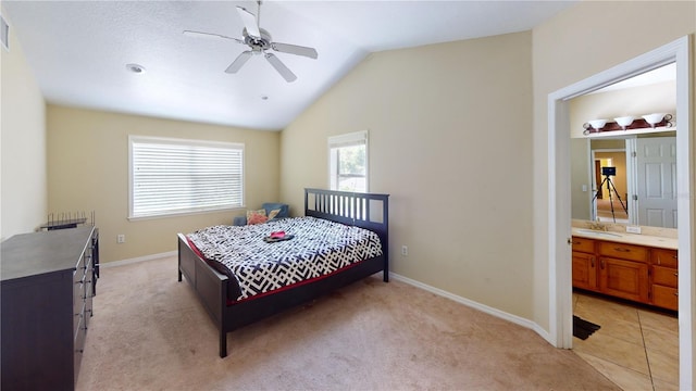 carpeted bedroom featuring multiple windows, ceiling fan, sink, and lofted ceiling