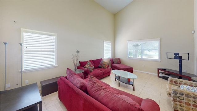 living room featuring light tile patterned floors, high vaulted ceiling, and a healthy amount of sunlight