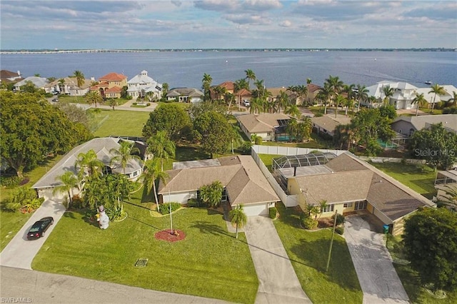 birds eye view of property featuring a water view and a residential view